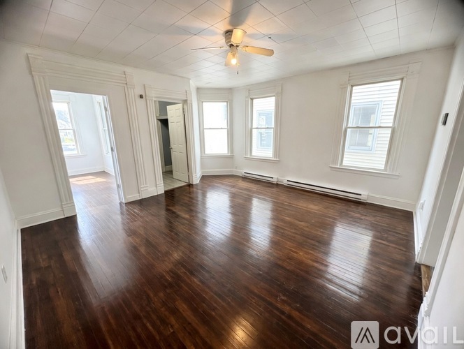 A room with wooden floors and white walls.