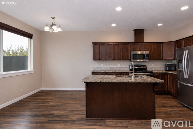 A kitchen with wooden cabinets and a granite countertop.