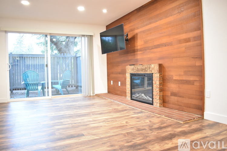 A modern living room with a fireplace and a television mounted above it.