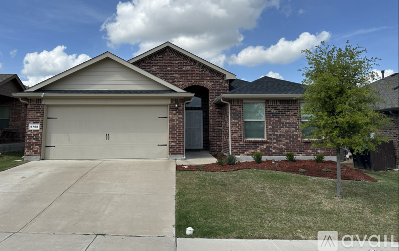 A house with a brick facade and a large garage door.