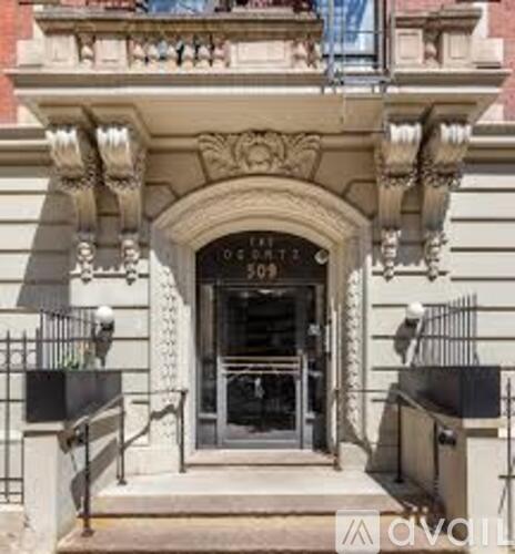 The image shows a building with a balcony and a door with the number 303 on it.