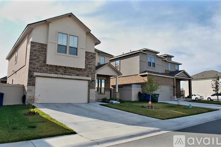 A row of houses with garages and driveways.