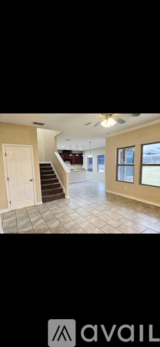 A living room with a staircase leading to the upper floor.
