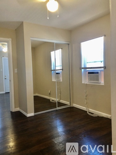 A room with a sliding door and wooden floors.