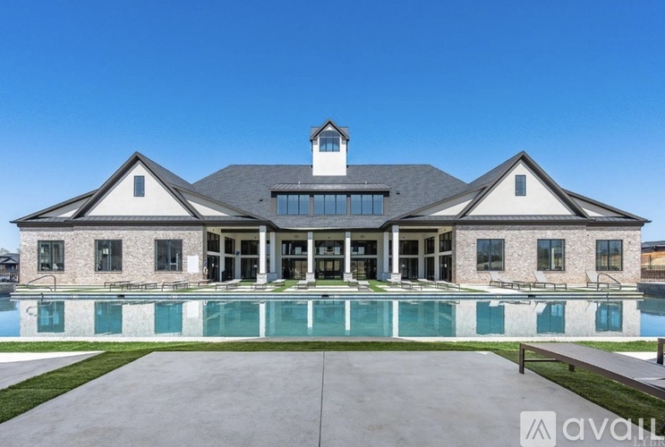 A large house with a pool in front.
