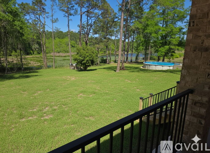 A backyard with a pool and a fence.