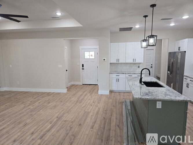 A kitchen with a countertop and cabinets is available for rent.