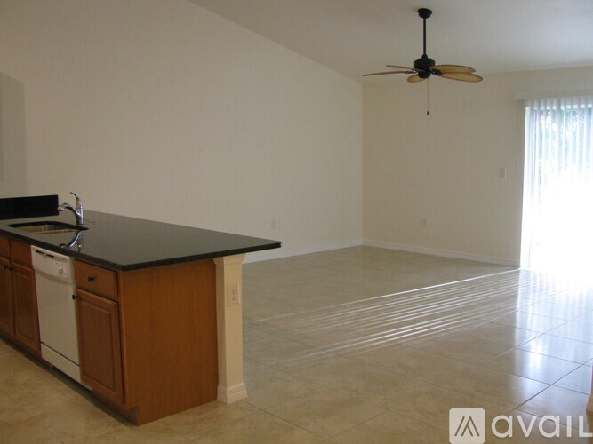 A kitchen with a black countertop and wooden cabinets.