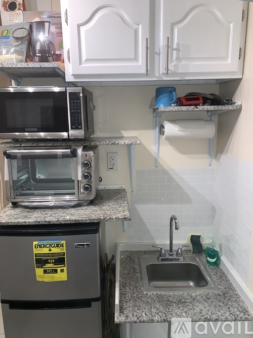 A kitchen with a stainless steel oven and microwave on the counter.