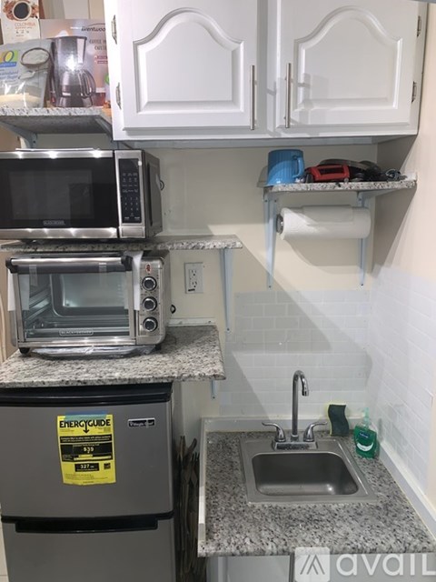 A kitchen with a stainless steel oven and microwave on the counter.