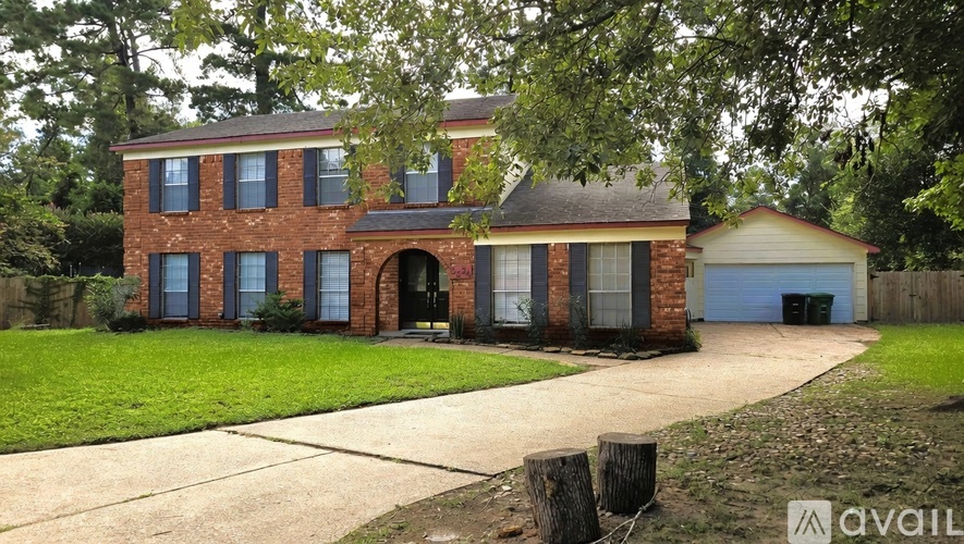 A house with a red brick exterior and a white garage door.