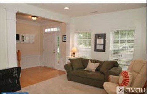 A living room with a couch and a chair.