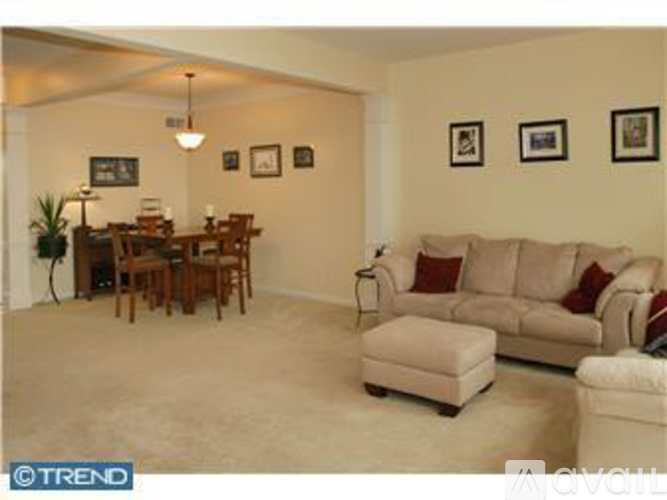 A living room with a couch, chair, and table.