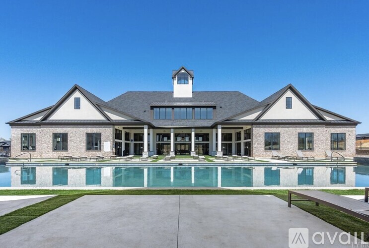A large house with a pool in front.