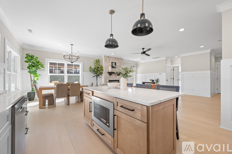 A modern kitchen with wooden cabinets and a white countertop.