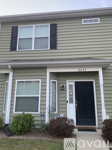 A house with a black front door and white trim.