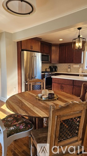 A kitchen with a wooden table and chairs.
