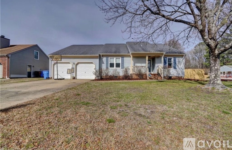 A house with a grey roof and white garage door is for sale.