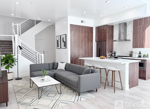 A modern living room with a grey sofa and a white coffee table.