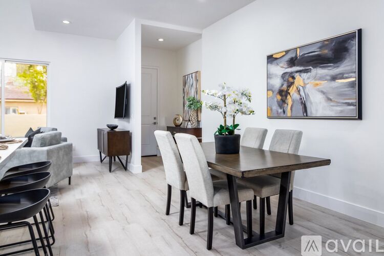 A modern dining room with a large table and chairs.