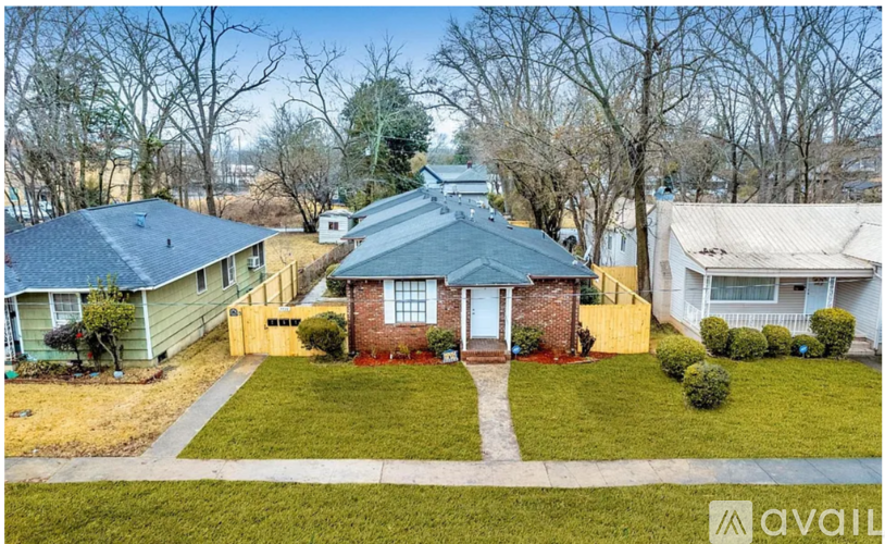 A house with a blue roof is for sale.