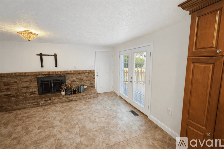 A living room with a fireplace and sliding glass doors.