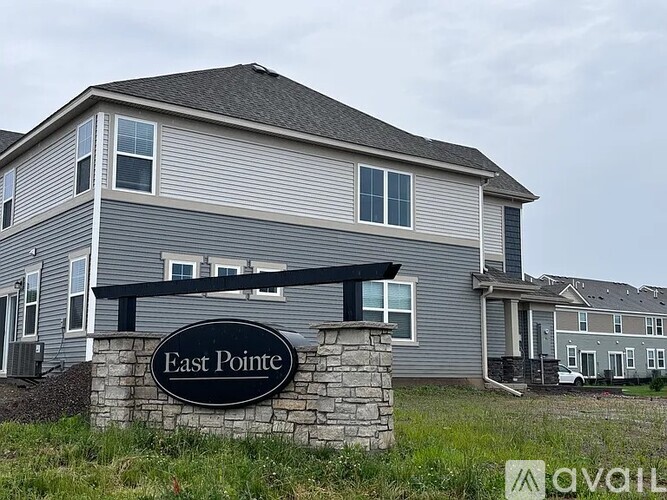 A house with a sign that says East Pointe in front of it.