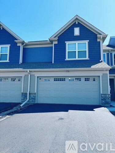 A blue house with a white garage door.