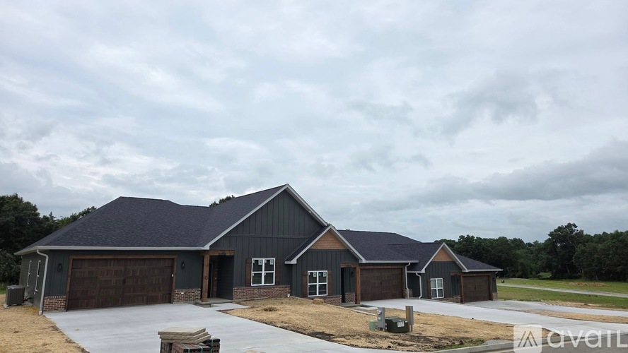 A two-story house with a garage is under construction.