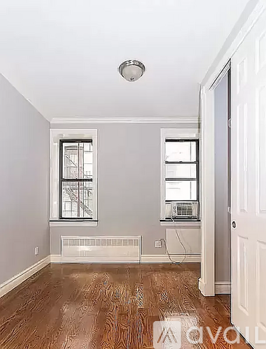A room with a window and a door.
