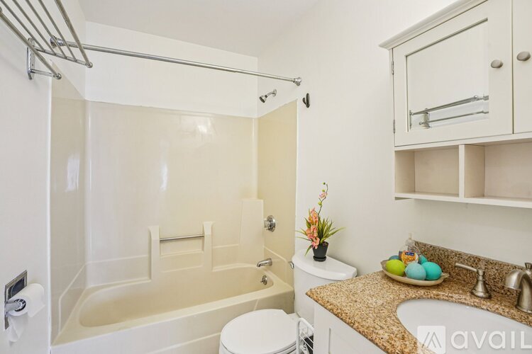 A bathroom with a toilet, sink, and bathtub.