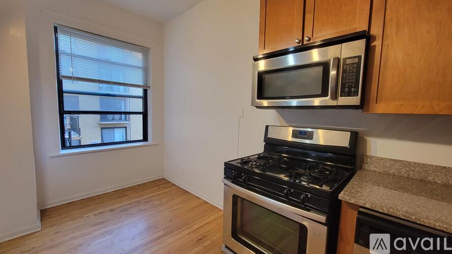 A kitchen with a stove, microwave, and oven.