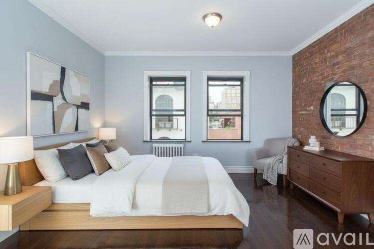 A bedroom with a large bed, a dresser, and a mirror.