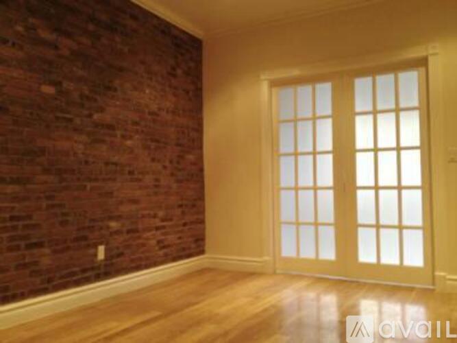 A room with a brick wall and a sliding door.