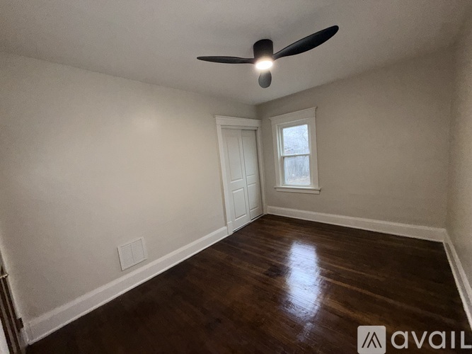 A room with a ceiling fan and a window.