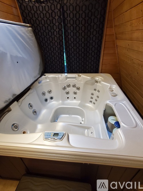 A hot tub with a control panel in the middle.
