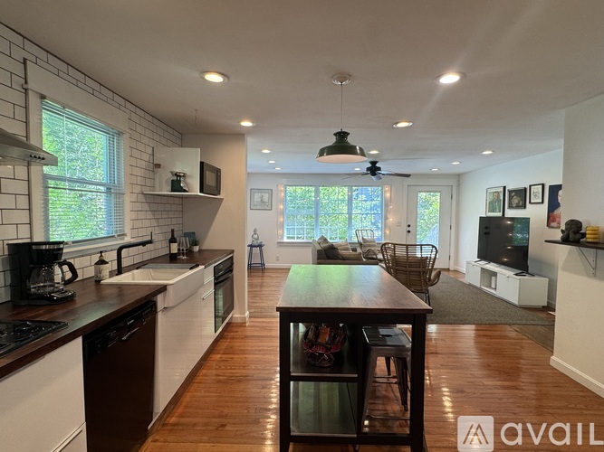 A kitchen with a table and chairs in the middle of the room.