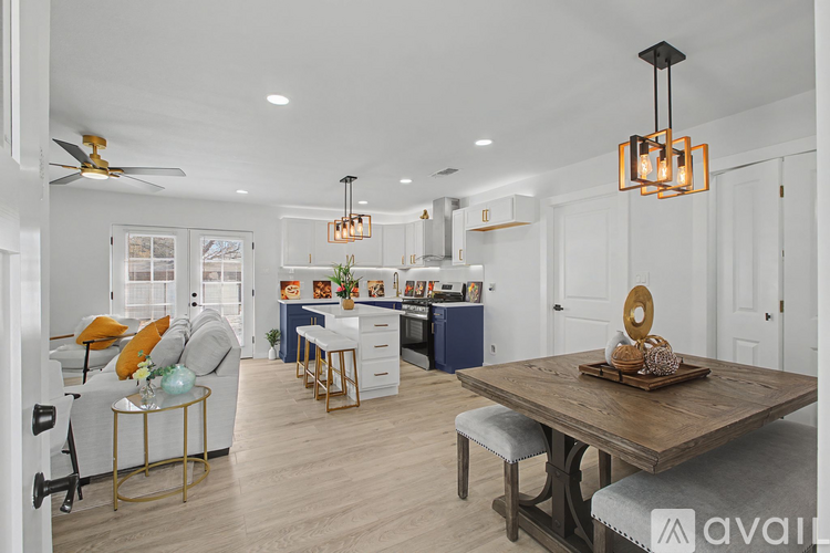 A modern kitchen with a dining table and chairs.