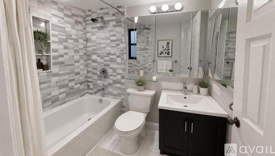 A bathroom with a white tub, toilet, and sink.