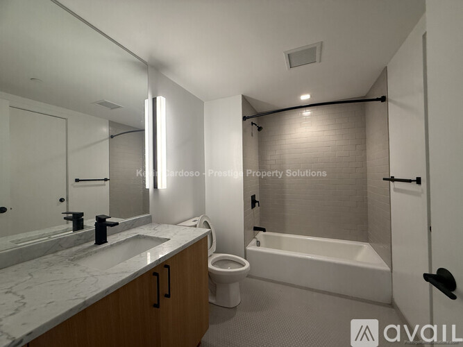 A bathroom with a marble countertop and a bathtub.