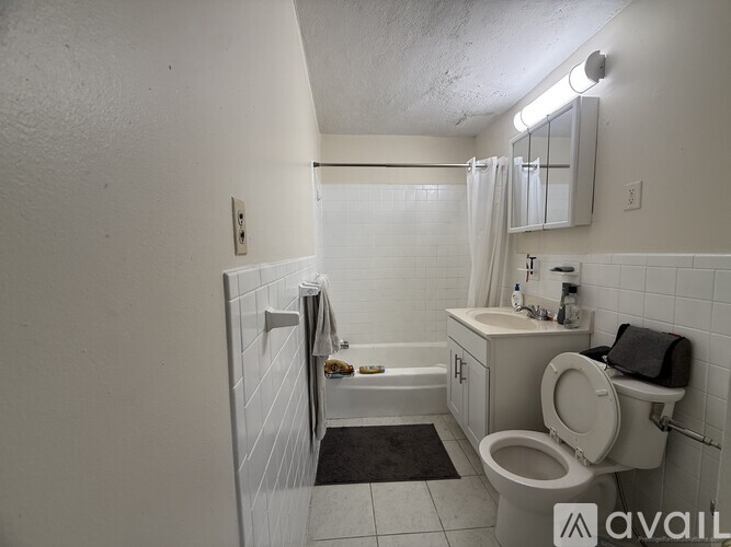 A bathroom with a toilet, sink, and bathtub.