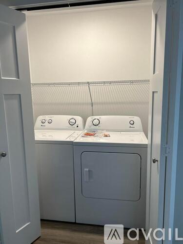 A small laundry room with a washer and dryer.