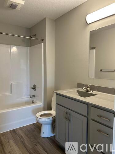 A bathroom with a toilet, sink, and bathtub.