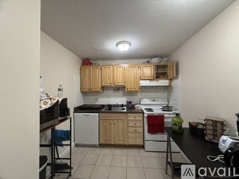 A kitchen with wooden cabinets and white appliances.