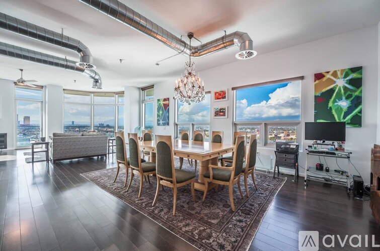 A modern dining room with a large table and chairs.