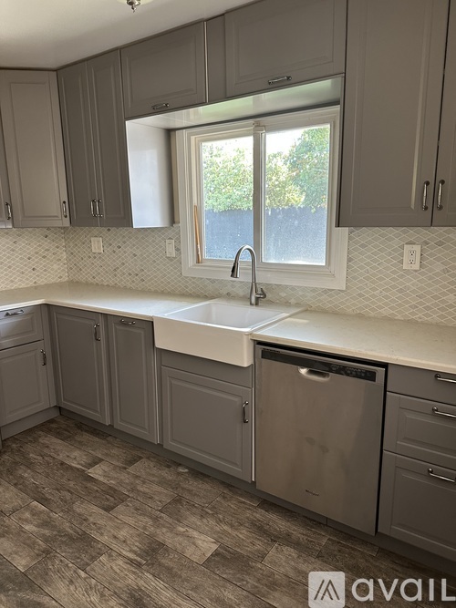 A kitchen with a window above the sink.