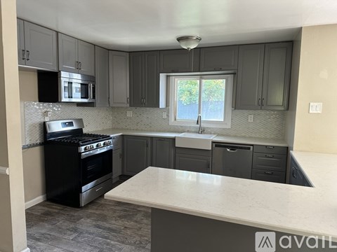 A kitchen with a black oven and a white counter.
