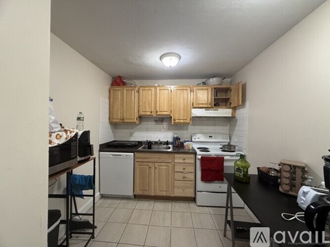 A kitchen with wooden cabinets and white appliances.