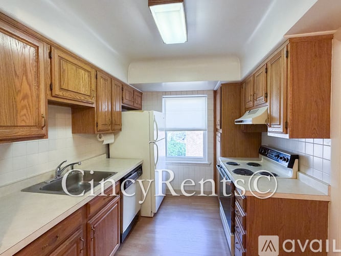 A kitchen with wooden cabinets and a stove top oven.