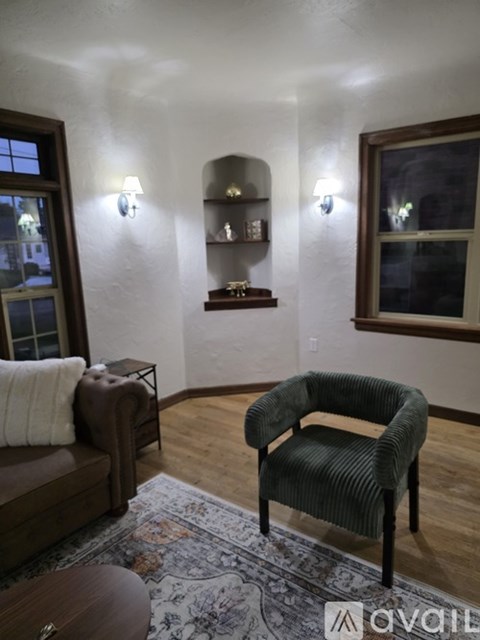 A living room with a brown chair and a brown couch.